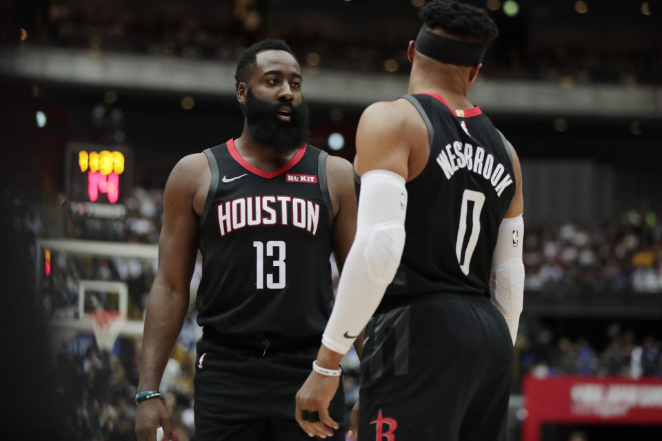 Houston Rockets' James Harden, left, talks to Russell Westbrook during the first half of an NBA preseason basketball game against the Toronto Raptors Tuesday, Oct. 8, 2019, in Saitama, near Tokyo. (AP Photo/Jae C. Hong)