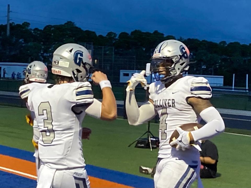 Gulliver Prep seniors Carson Haggard (3) and De’Carlo Donaldson celebrate the first of their four touchdowns against Benjamin on Sept. 17, 2021 in Palm Beach Gardens.