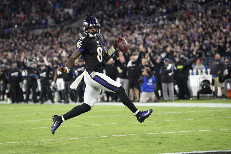 Baltimore Ravens quarterback Lamar Jackson scores on a run against the New England Patriots during the first half of an NFL football game, Sunday, Nov. 3, 2019, in Baltimore. (AP Photo/Nick Wass)