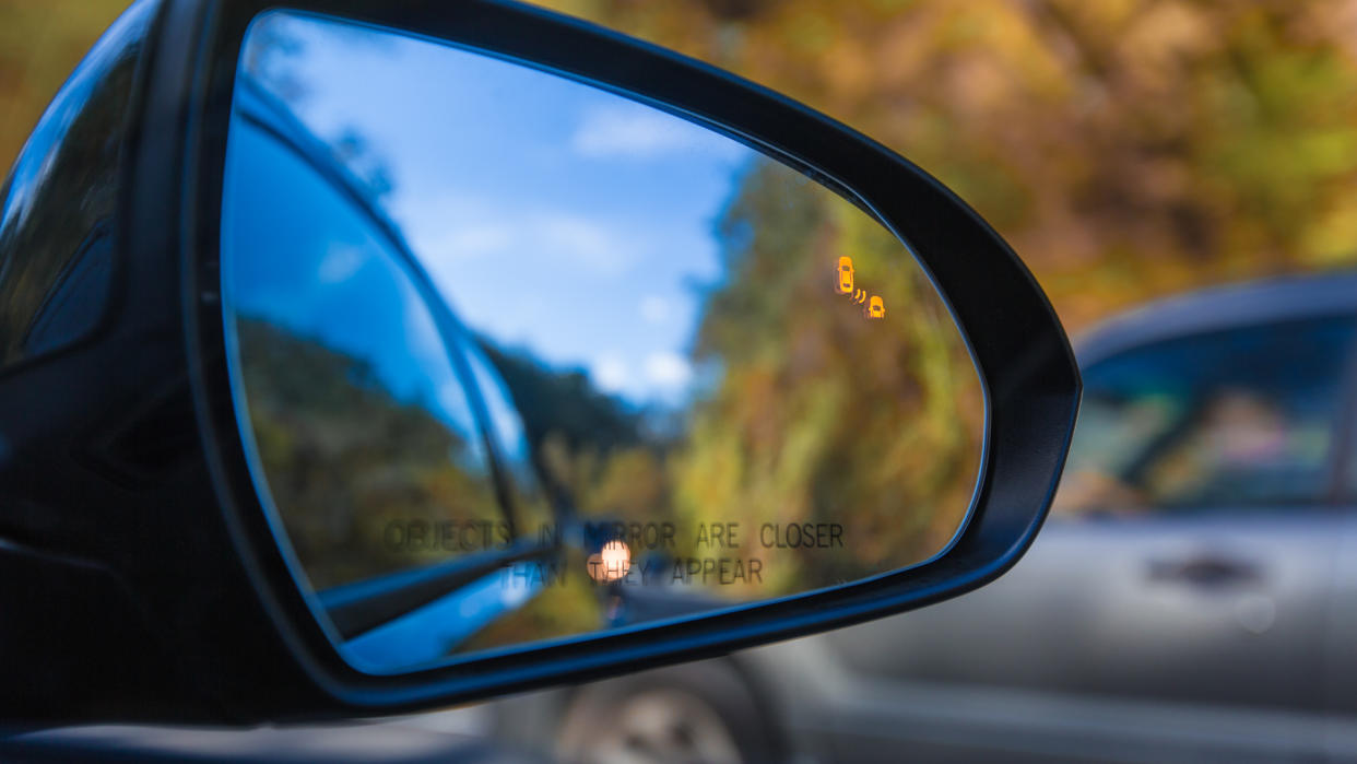 Objects in mirror are closer than they appear on car with Blind Spot Assist Warning LED Sensor Light.