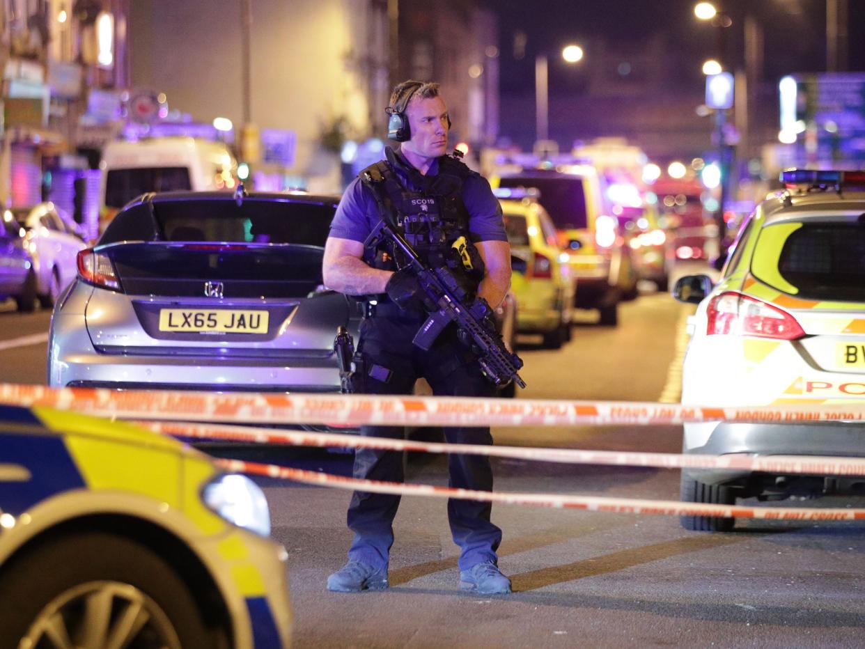 An armed police officer mans a cordon on the Seven Sisters Road at Finsbury Park in north London, where one person has been arrested after a vehicle struck pedestrians: PA