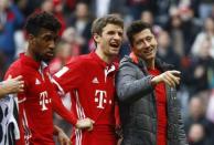 Football Soccer - Bayern Munich v Eintracht Frankfurt - German Bundesliga - Allianz Arena, Munich, Germany - 11/03/17 - Bayern Munich's Robert Lewandowski, Thomas Mueller and Kingsley Coman react at the end of the match. REUTERS/Wolfgang Rattay