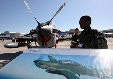 FILE PHOTO: A Brazilian soldier stands guard near a A-29 Super Tucano during the opening ceremony of the Santiago's Aviation Fair, known as FIDAE, at Chile's international airport March 27, 2006. REUTERS/Ivan Alvarado/Files