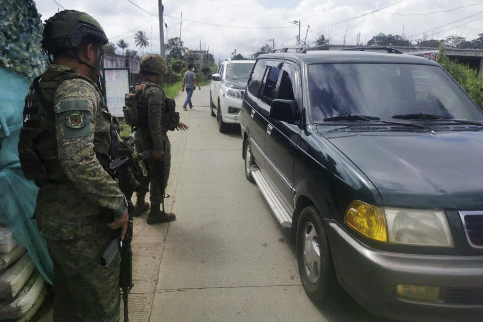 Filipino troopers man a checkpoint near the site where a bomb exploded in Marawi, southern Philippines on Sunday Dec. 3, 2023. A powerful explosion believed caused by a bomb ripped through a Catholic Mass and killed several people and wounded dozens of others Sunday in a predominantly Muslim city in the southern Philippines, officials said. (AP Photo/Froilan Gallardo)