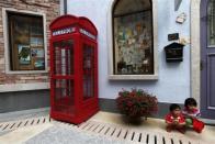 Children pose for pictures at the replica of Austria's UNESCO heritage site, Hallstatt village, in China's southern city of Huizhou in Guangdong province, June 1, 2012.