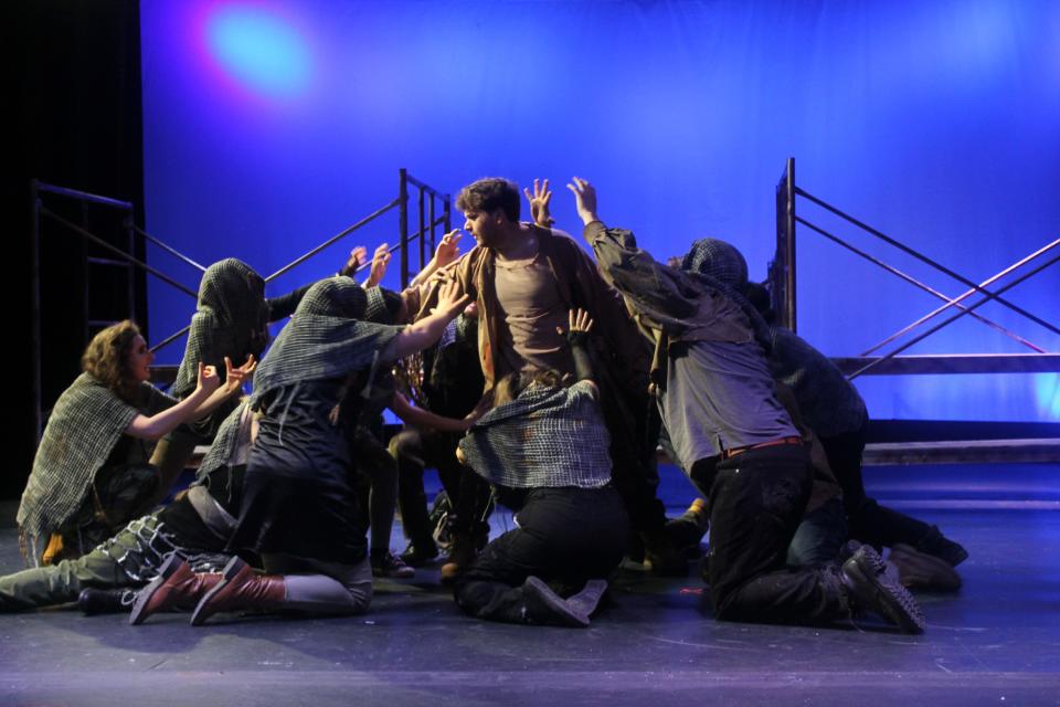 Lame and sick beggars surround Jesus, played by Christian Leigh, in this scene from College Light Opera Company's production of "Jesus Christ Superstar."