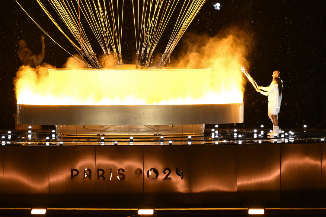 26 July 2024, France, Paris: Olympia, Paris 2024, opening ceremony of the Summer Olympics, Marie-Jose Perec and Teddy Riner light the Olympic flame. Photo: Marijan Murat/dpa (Photo by Marijan Murat/picture alliance via Getty Images)