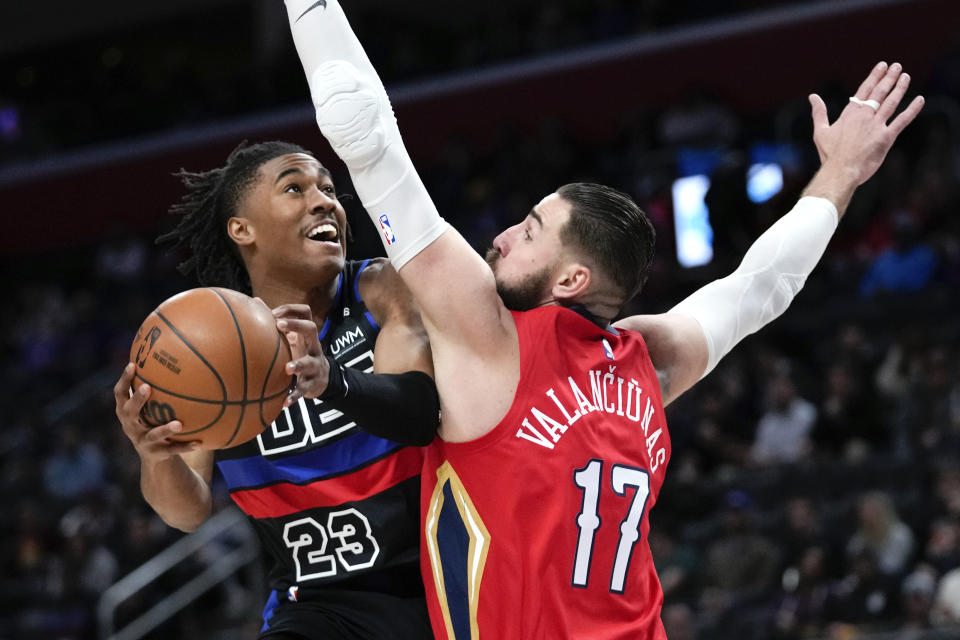 Detroit Pistons guard Jaden Ivey (23) drives on New Orleans Pelicans center Jonas Valanciunas (17) in the first half of an NBA basketball game in Detroit, Friday, Jan. 13, 2023. (AP Photo/Paul Sancya)