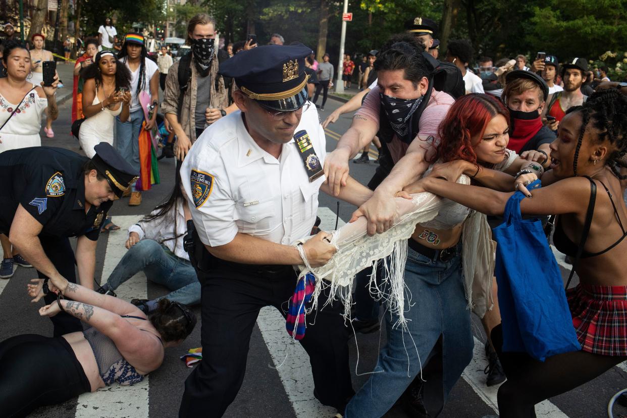 NYPD clash with revelers during Gay Pride festivities after trying to clear a street on the edge of Washington Square Park in the Greenwich Village neighborhood of Manhattan, New York.