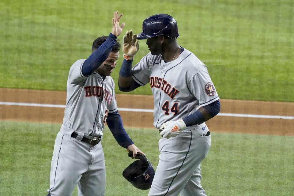 Houston Astros' Jose Altuve, left, and Yordan Alvarez celebrate a two run-home run hit by Alvarez in the second inning of a baseball game against the Texas Rangers in Arlington, Texas, Monday, Sept. 13, 2021. (AP Photo/Tony Gutierrez)