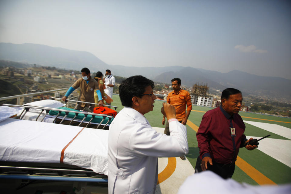 Hospital staff get ready to receive the injured from an avalanche on the helipad of Grandy hospital, in Katmandu, Nepal, Friday, April 18, 2014An avalanche swept down a climbing route on Mount Everest early Friday, killing at least 12 Nepalese guides and leaving three missing in the deadliest disaster on the world's highest peak. (AP Photo/Niranjan Shrestha)