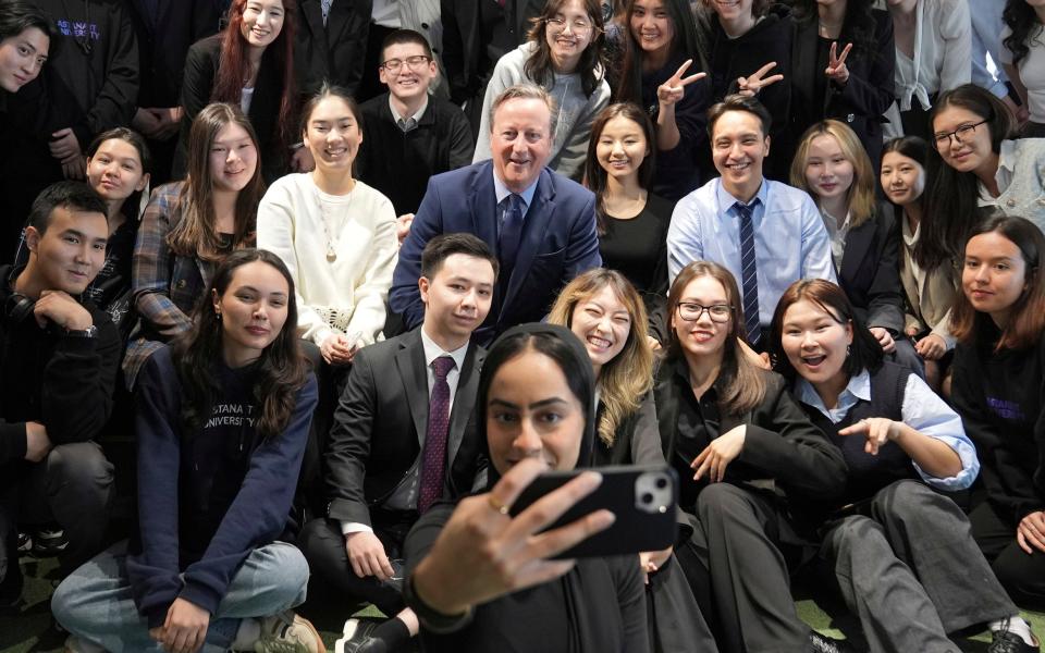 Lord Cameron, the Foreign Secretary, poses for a photo with a group of students following a Q&A session at Astana IT University in Astana, Kazakhstan