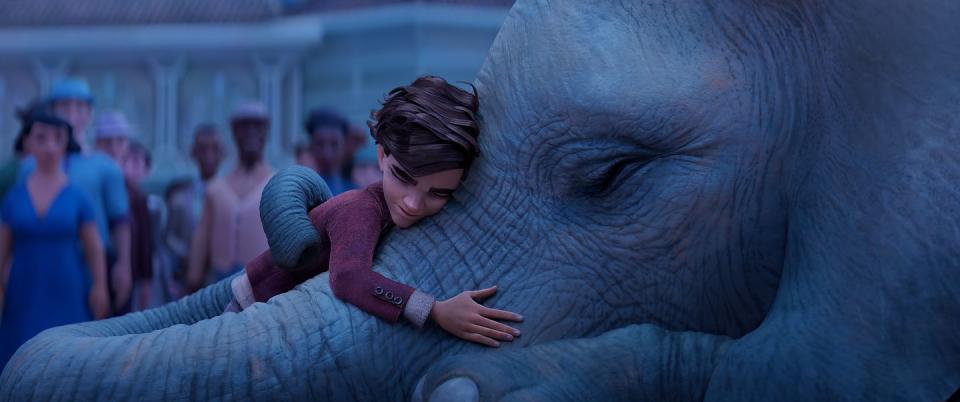 peter hugs an elephant in a scene from the magician's elephant, a good housekeeping pick for best kids movies 2023