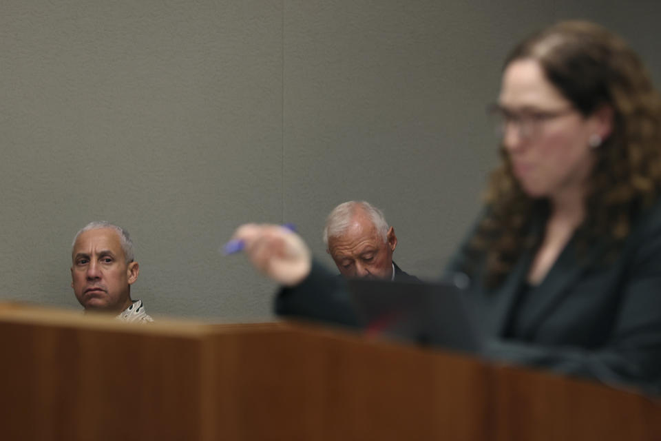 Albert "Ian" Schweitzer, left, looks on as Innocence Project attorney Susan Freidman speaks during Schweitzer's court case Tuesday, Jan. 24, 2023, in Hilo, Hawaii. Attorneys for Schweitzer, imprisoned for more than 20 years after his conviction for the 1991 sexual assault, kidnapping, and murder of a white woman visiting the Big Island, ask a judge Tuesday to dismiss his conviction due to new evidence, including DNA testing in the case. (Marco Garcia/The Innocence Project via AP Images)