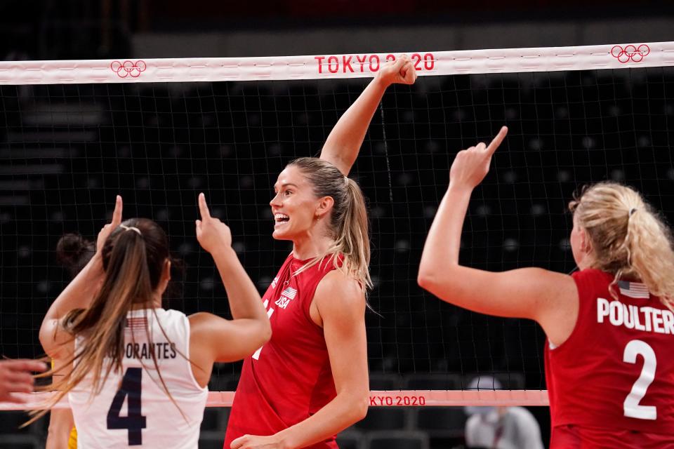 USA players Alex Obert (4), Jesse Smith (11) and Jordyn Poulter (2) react after winning a point in the women's volleyball gold medal match.