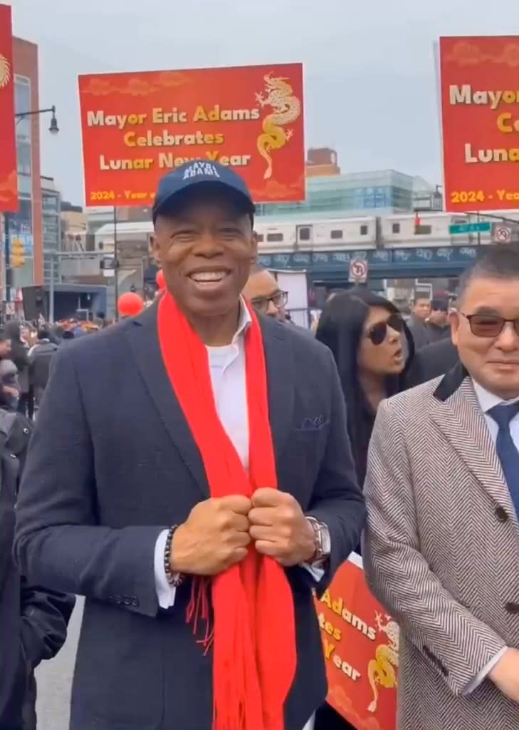 Eric Adams sported a red scarf at Lunar New Year events he attended last weekend including this one in Flushing, Queens. The scarf is a potent symbol of the Chinese Communist Party.