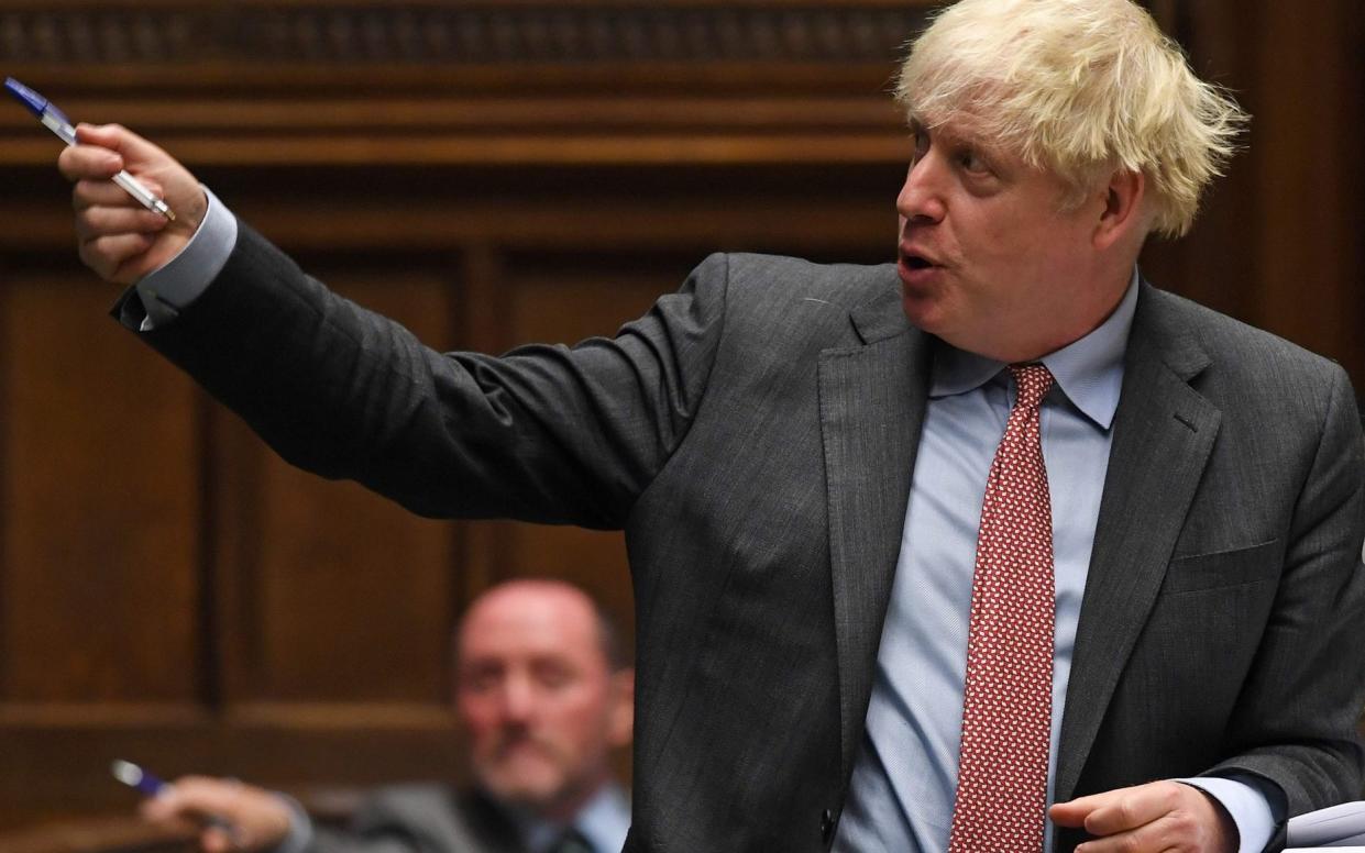 A handout photograph released by the UK Parliament shows Britain's Prime Minister Boris Johnson attending the weekly Prime Minister's Questions (PMQs) in the House of Commons in London on September 30, 2020. - British Prime Minister Boris Johnson was spared a rebellion by his own MPs over coronavirus regulations on Wednesday but the House of Commons speaker accused him of treating lawmakers with "contempt". More than 50 MPs in Johnson's Conservative party had threatened to support a motion demanding more say over future rules to stop the spread of the virus, accusing ministers of governing "by decree". (Photo by JESSICA TAYLOR / various sources / AFP) / RESTRICTED TO EDITORIAL USE - MANDATORY CREDIT " AFP PHOTO / UK PARLIAMENT " - NO USE FOR ENTERTAINMENT, SATIRICAL, MARKETING OR ADVERTISING CAMPAIGNS - EDITORS NOTE THE IMAGE HAS BEEN DIGITALLY ALTERED AT SOURCE TO OBSCURE VISIBLE DOCUMENTS (Photo by JESSICA TAYLOR/AFP via Getty Images) - JESSICA TAYLOR/AFP