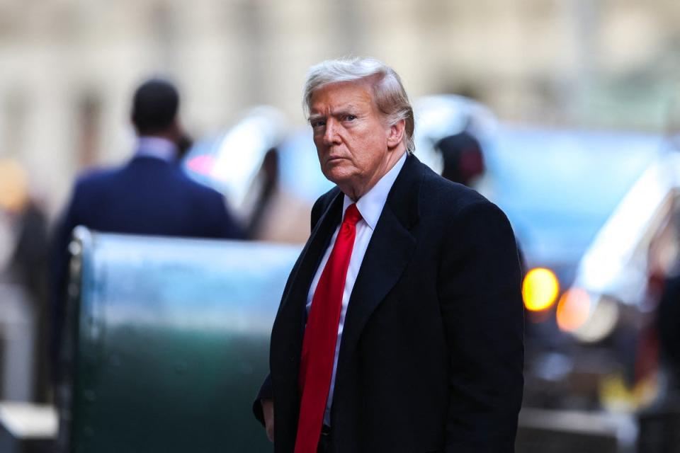 Donald Trump arrives at 40 Wall Street after a pretrial conference in Manhattan criminal court on 25 March. (AFP via Getty Images)