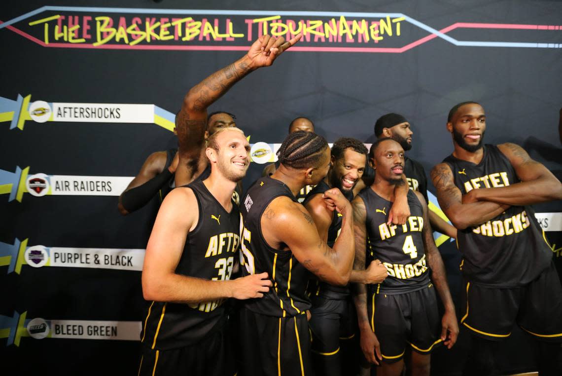 The AfterShocks pose together after winning the regional championship in The Basketball Tournament.