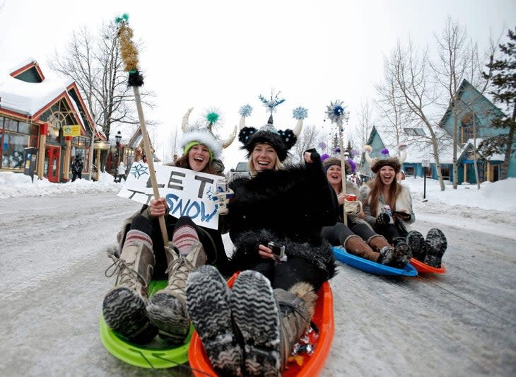 <span class="article__caption">Sledding down Main Street, Breck. There are a parade, giant bonfire, costumes, and--oh yes--skiing and snowboarding.</span> (Photo: Breckenridge Tourism Office)