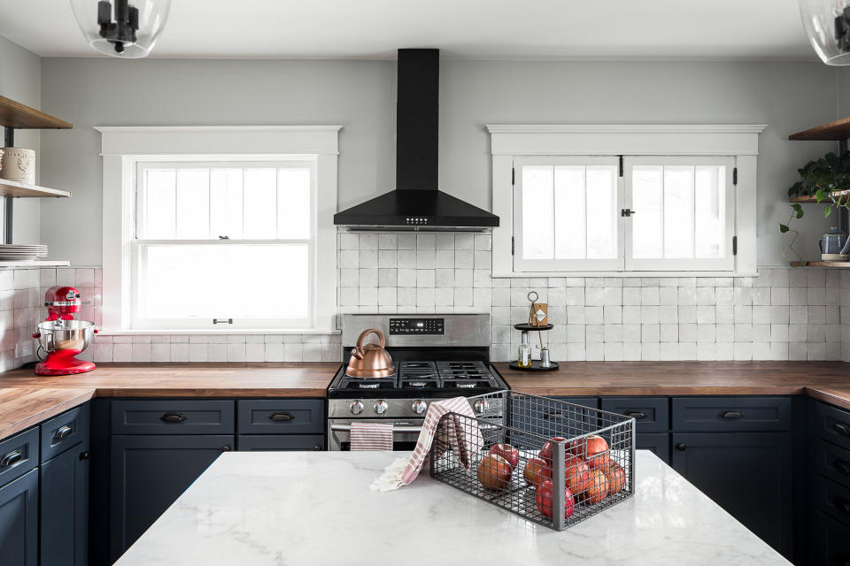 A kitchen with white walls and zellige backsplash tiles