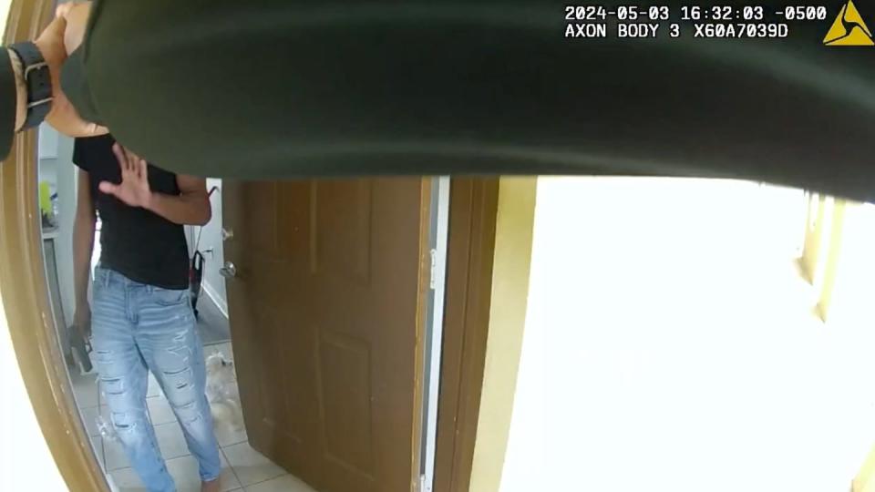 A still from body camera footage captured by an Okaloosa County Sheriff's Deputy shows a deputy pointing his firearm at Senior Airman Roger Fortson, who is holding a handgun, before fatally shooting him at a Florida apartment complex May 3. (Okaloosa County Sheriff's Office)