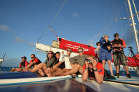 In this photo released by Tourism Queensland, people prepare to view a total solar eclipse while on a tour boat at Michelmas Cay on the Great Barrier Reef in Queensland state, Australia, Wednesday, Nov. 14, 2012. Starting just after dawn, the eclipse cast its 150-kilometer (95-mile) shadow in Australia's Northern Territory, crossed the northeast tip of the country and was swooping east across the South Pacific, where no islands are in its direct path. (AP Photo/Tourism Queensland, Ben Southall) EDITORIAL USE ONLY