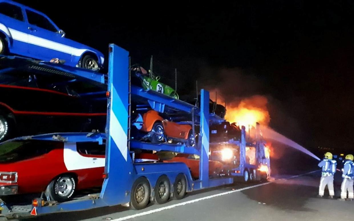 A transporter carrying a dozen novelty cars including a Batmobile caught fire - SWNS.com