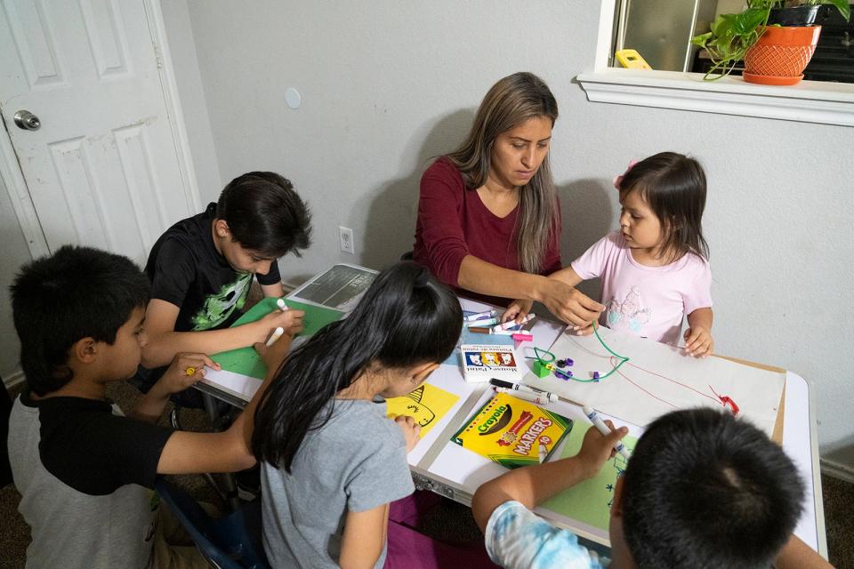 Arlett Mireles crafts with her children at their home last month. The family's Medicaid coverage was stopped in August, and she is worried about what to do if any of her five kids needs to go to the hospital.