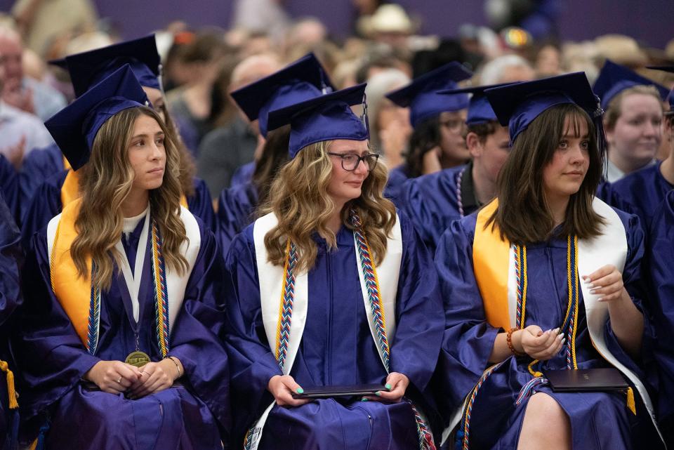 Gianna Baker, center, gets emotional after leading the tassel change as senior class president during the Rye High School commencement ceremony on Thursday, May 25, 2023.