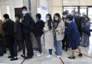 People stand in a line to a polling station during the presidential election in Tashkent, Uzbekistan, Sunday, Oct. 24, 2021. Uzbeks voted Sunday in a presidential election that the incumbent is expected to win in a landslide against weak competition. Although Shavkat Mirziyoyev has relaxed many of the policies of his dictatorial predecessor, he has made little effort at political reform. He took office in 2016 upon the death of Islam Karimov and faces four relatively low-visibility candidates who did not even show up for televised debates. (AP Photo)