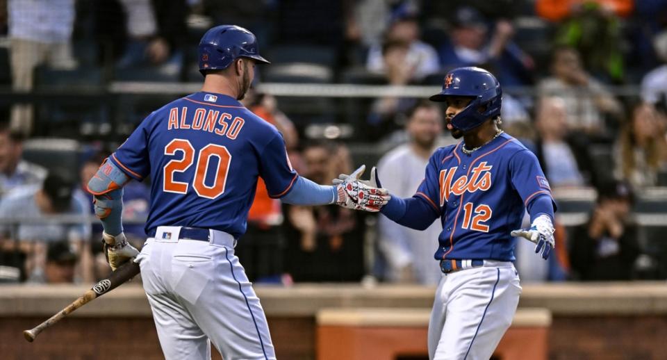 New York Mets shortstop Francisco Lindor (12) is greeted by first baseman Pete Alonso (20) after hitting a home run against the Philadelphia Phillies during the fourth inning at Citi Field.