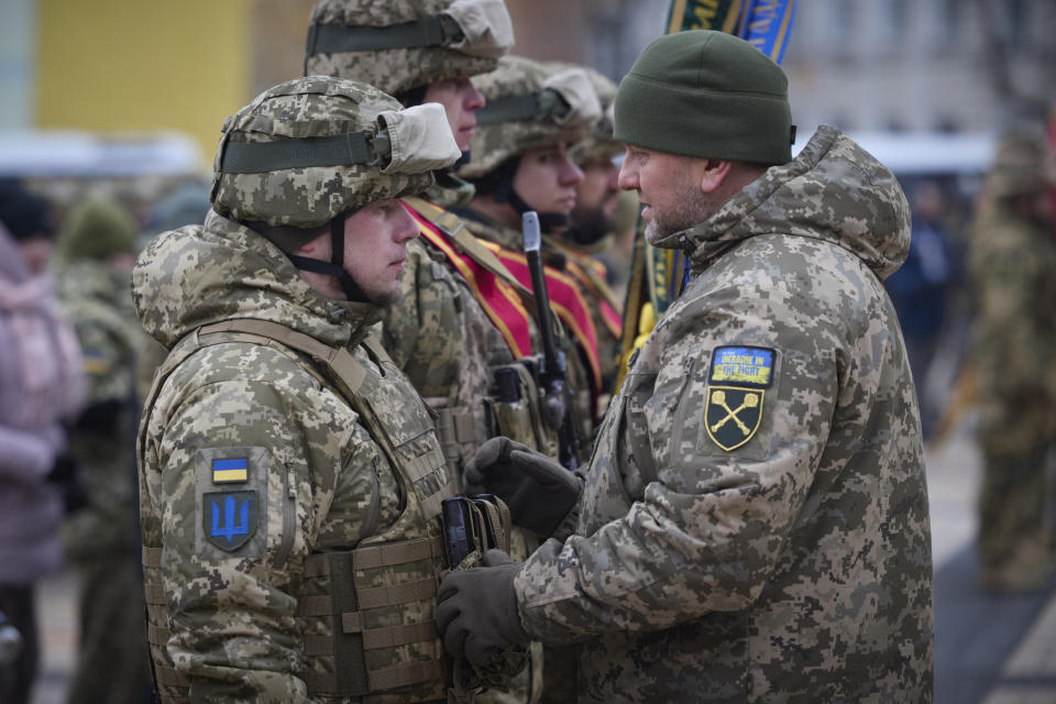 Commander-in-Chief of Ukraine's Armed Forces Valeriy Zaluzhny, right, talks to an officer during a commemorative event on the occasion of the Russia Ukraine war one year anniversary, in Kyiv, Ukraine, Friday, Feb. 24, 2023. (Ukrainian Presidential Press Office via AP)