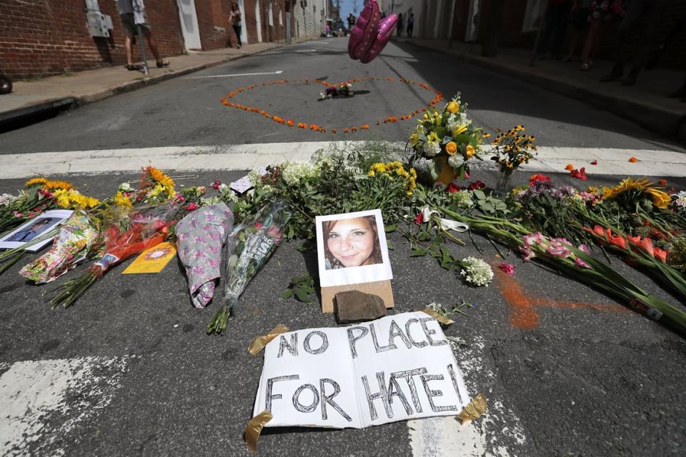 <div class="inline-image__caption"><p>Flowers surround a photo of 32-year-old Heather Heyer.</p></div> <div class="inline-image__credit">Chip Somodevilla/Getty</div>