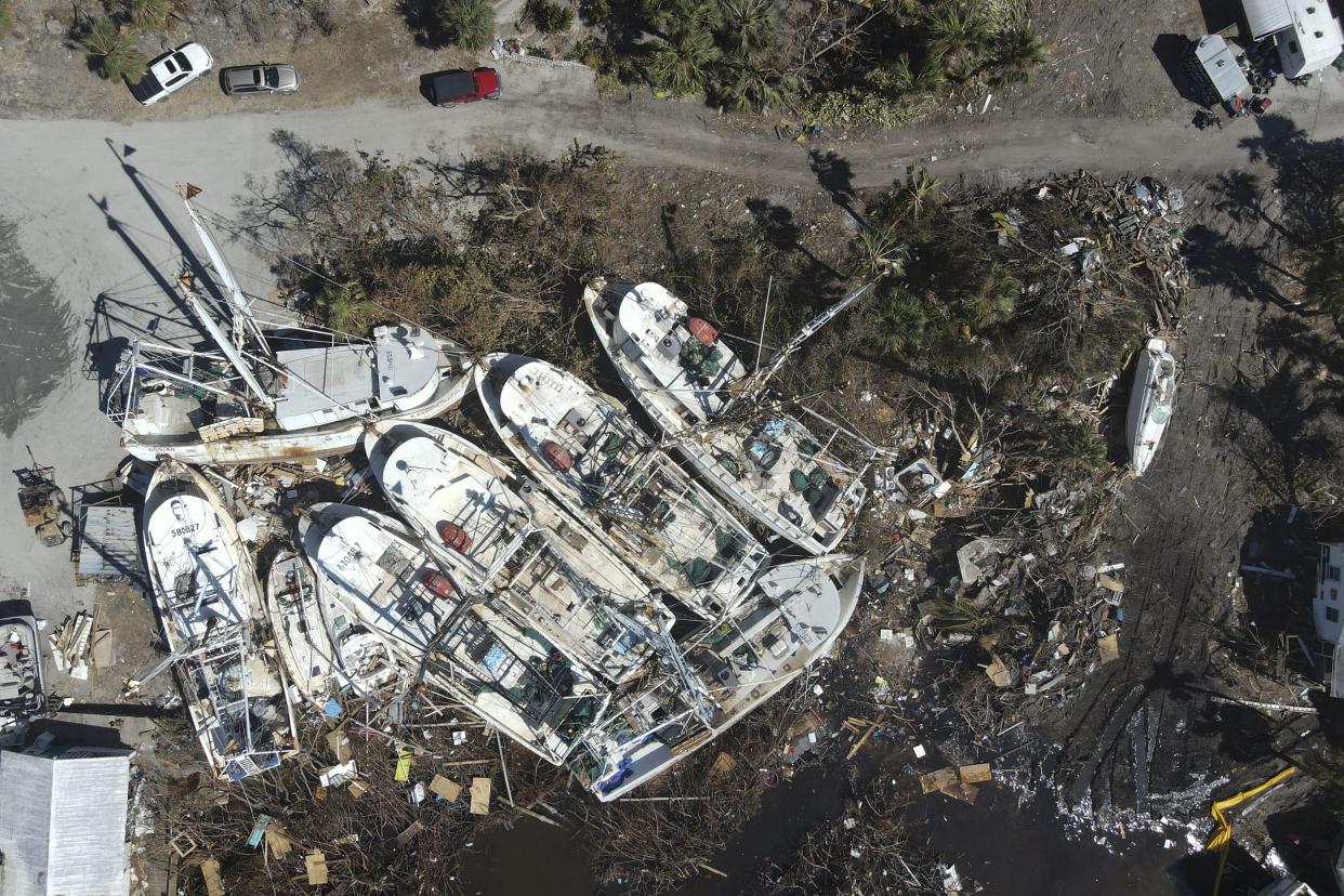 In this photo shot with a drone, a group of shrimp boats is left grounded following the passage of Hurricane Ian, on San Carlos Island in Fort Myers Beach, Fla., Friday, Oct. 7, 2022.