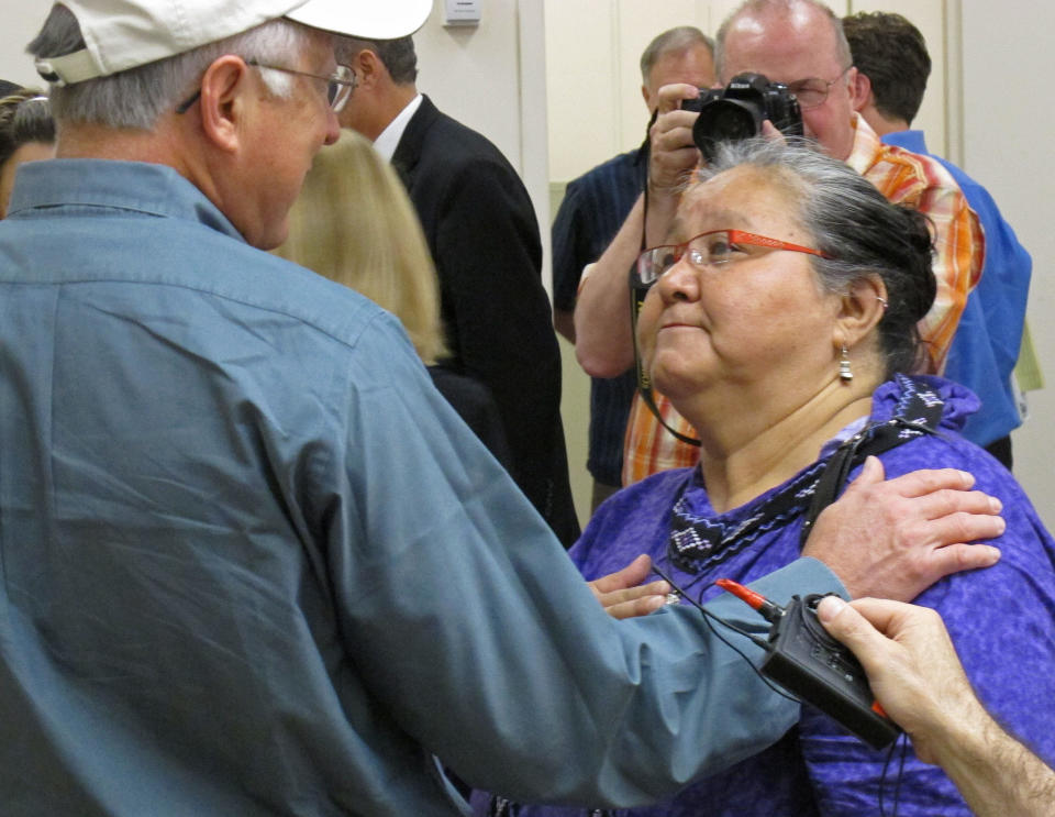 U.S. Interior Secretary Ken Salazar speaks speaks to Caroline Cannon of Point Hope, Alaska, following his press conference Monday, Aug. 13, 2012, in Anchorage, Alaska. Salazar announced a proposed management plan for the National Petroleum Reserve-Alaska. Cannon said she spoke to him about the social impact of development on Alaska Natives, especially the high rate of suicide. (AP Photo/Mark Thiessen)