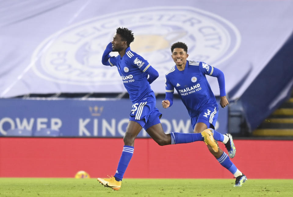 Leicester's Wilfred Ndidi, left, celebrates after scoring his team's opening goal during the English Premier League soccer match between Leicester City and Chelsea at the King Power Stadium in Leicester, England, Tuesday, Jan. 19, 2021. (Michael Regan/Pool via AP)