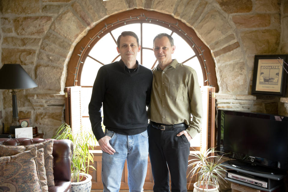 In this March 23, 2014 photo, Carl Bechdel, left, and his husband Dan Miller, pose for a photograph at their home in Harrisburg, Pa. It took two months of near daily phone calls and emails to an insurer for Bechdel and Miller to get family coverage under the federal health law. The couple was initially told their application was not processed because Pennsylvania doesn't recognize their marriage. Gay couples are finding that access to such family plans is not guaranteed, as the Obama administration seeks belatedly to ensure equitable coverage is available for same-sex spouses. (AP Photo/Matt Rourke)