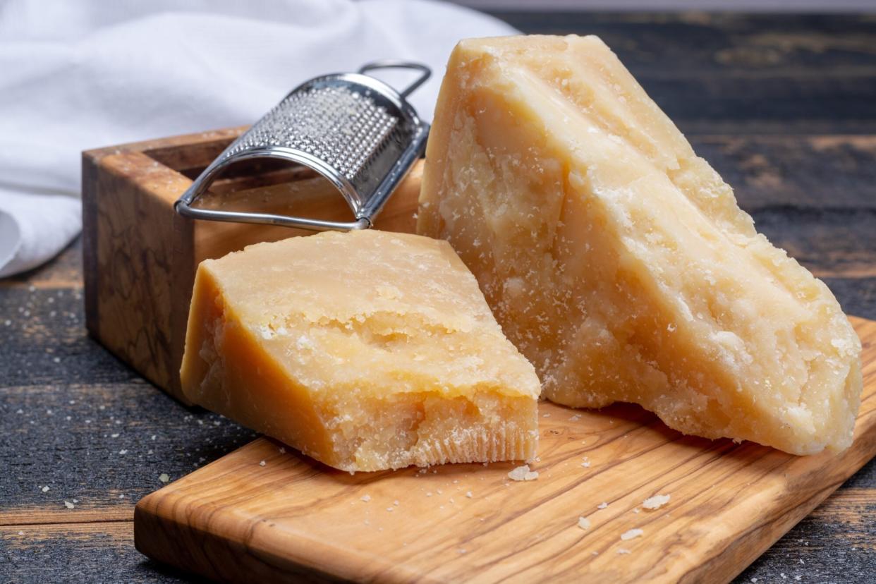 Parmigiano-Reggiano hard cheese on cutting board