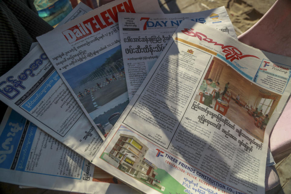 FILE - In this Feb. 2, 2021, file photo, local newspapers are displayed in a newspaper stall in Yangon, Myanmar. The front page of Standard Time Daily, right, reads "Meeting of National Defence and Security Council held in Naypyitaw." Myanmar’s military-controlled government is seeking to suppressing media coverage of protests against their seizure of power as journalists and ordinary citizens strive to keep people inside and outside of the country informed about what is happening. (AP Photo/File)