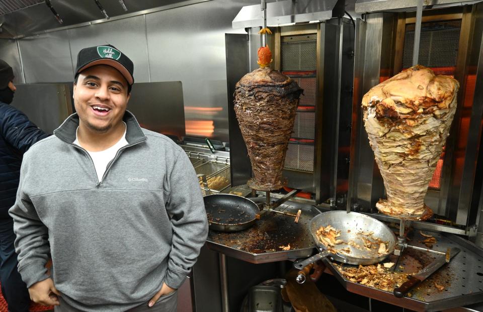 Mohammed Abdullah stands in front of the Shawarma Station vertical rotisseries at 64 East Chicago.