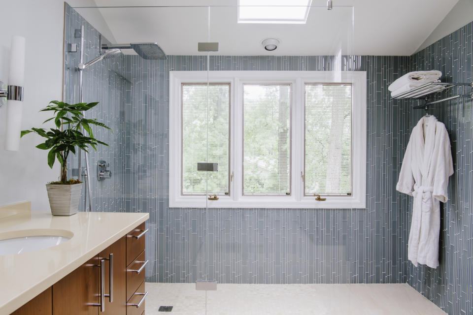 This photo shows a Bethesda, M.D., master bathroom. Interior designer Nadia Subaran says homeowners increasingly want glass-enclosed showers that they can walk directly into without any step or door, as seen in this design by Aidan Design. (Robert Radifera/Aidan Design via AP)