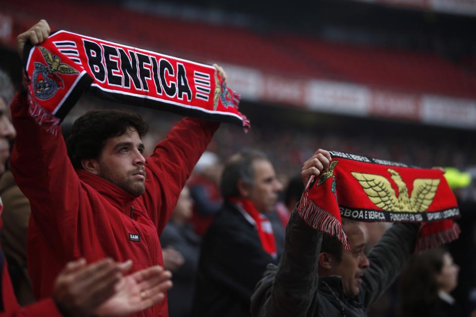 Supporters sing as the funeral car containing Eusebio's coffin cross the Luz stadium in Lisbon