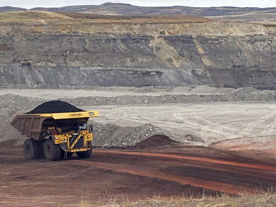 FILE - In this March 28, 2017, file photo, a dump truck hauls coal at Contura Energy's Eagle Butte Mine near Gillette, Wyo.Two coal mines in Wyoming and one in West Virginia owned by a company in bankruptcy could reopen if a judge approves a purchase offer. Court documents show Bristol, Tennessee-based Contura Energy has offered $20.6 million for the mines owned by Milton, West Viginia-based Blackjewel LLC. The mines have been closed since Blackjewel filed for bankruptcy July 1, 2019. (AP Photo/Mead Gruver, File)