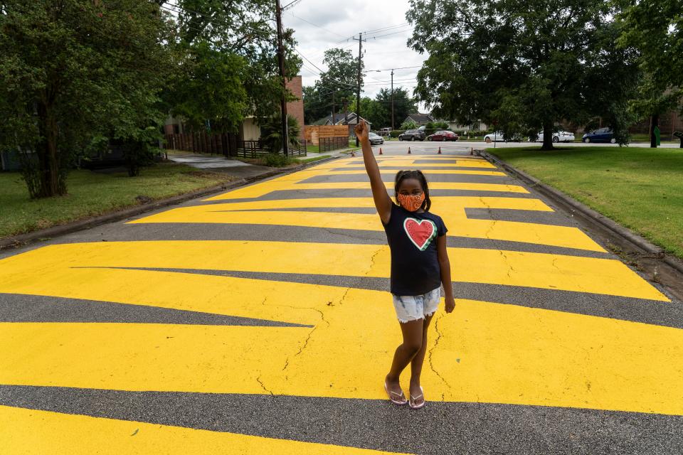 Kainaan Jones, 9, poses on ‘Black Towns Matter’ painted on a street on 19 June, 2020 in Houston, Texas. (Getty Images)
