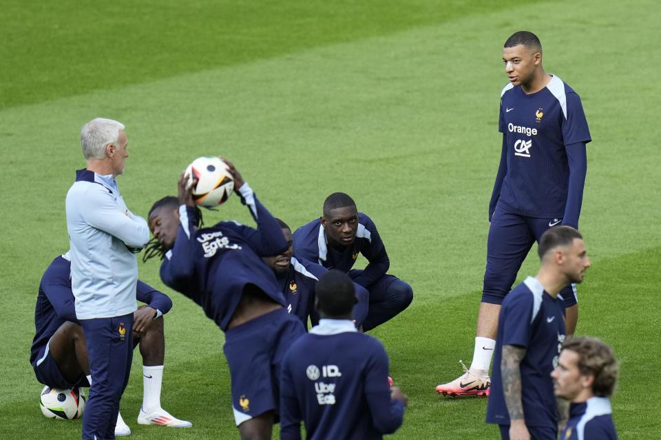 France's Kylian Mbappe, right, top, speaks with his head coach Didier Deschamps during a training session in Paderborn, Germany, Wednesday, June 19, 2024. France will play against Netherland during their Group D soccer match at the Euro 2024 soccer tournament on June 21. (AP Photo/Hassan Ammar)