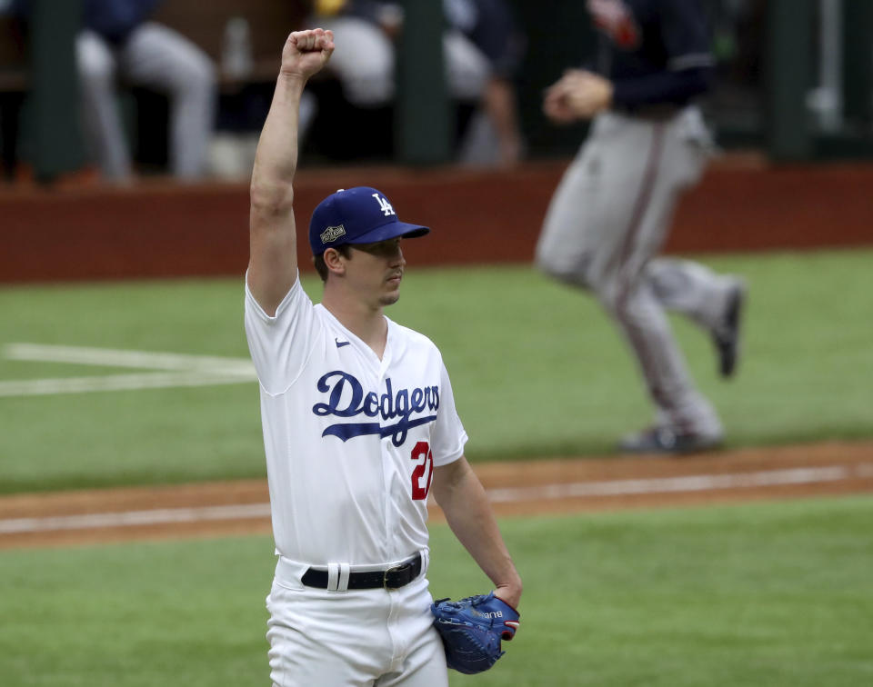 Los Angeles Dodgers starting pitcher Walker Buehler reacts after right fielder Mookie Betts (not pictured) makes a catch getting out Atlanta Braves designated hitter Marcell Ozuna (not pictured) during the fifth inning in Game 6 Saturday, Oct. 17, 2020, for the best-of-seven National League Championship Series at Globe Life Field in Arlington, Texas. (Curtis Compton/Atlanta Journal-Constitution via AP)