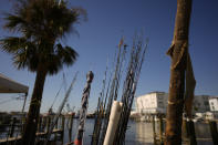 Fishing rods recovered by a small commercial fisherman whose two boats were destroyed in the passage of Hurricane Ian, sit on a wharf in Fort Myers Beach, Fla., Friday, Oct. 7, 2022. (AP Photo/Rebecca Blackwell)