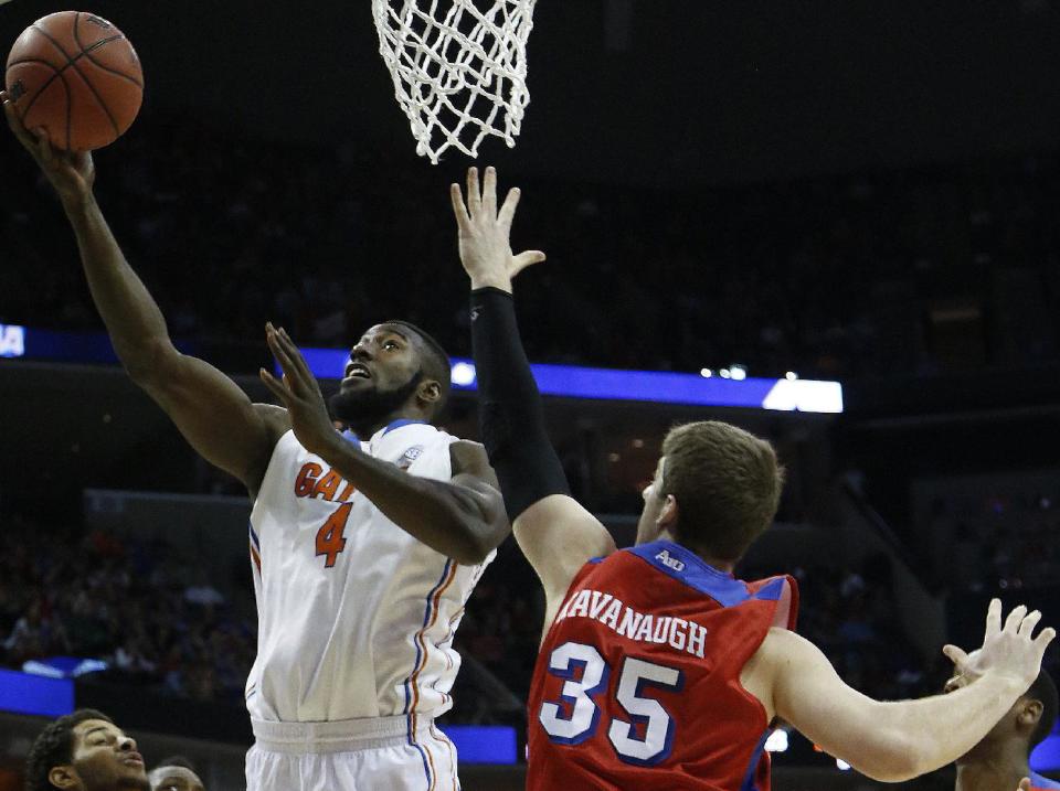 Florida center Patric Young (4) shoots against Dayton forward/center Matt Kavanaugh (35) during the first half in a regional final game at the NCAA college basketball tournament, Saturday, March 29, 2014, in Memphis, Tenn. (AP Photo/Mark Humphrey)