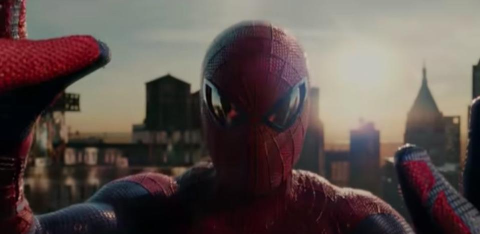 Peter, in his Spider-Man suit, staring at himself in a glass window in "The Amazing Spider-Man"